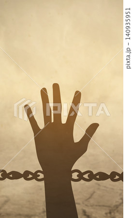 Conceptual silhouette of a hand reaching up behind a chain, symbolizing freedom, hope, human rights, and overcoming captivity Conceptual silhouette of a hand reaching up behind a chain, symbolizing freedom, hope, human rights, and overcoming captivity 140935951