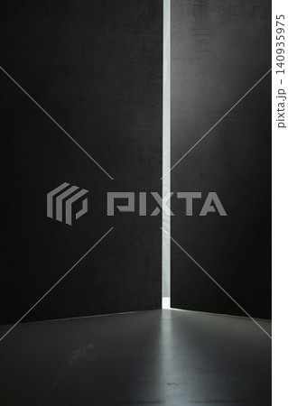 A conceptual abstract image showing a bright vertical beam of light shining through a narrow crack between two dark textured walls, symbolizing hope, opportunity, and escape A conceptual abstract image showing a bright vertical beam of light shining through a narrow crack between two dark textured walls, symbolizing hope, opportunity, and escape 140935975