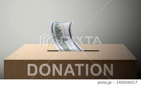 A cardboard donation box with a dollar bill being inserted into the slot, representing charity, giving, and financial support on a neutral background. A cardboard donation box with a dollar bill being inserted into the slot, representing charity, giving, and financial support on a neutral background. 140936017