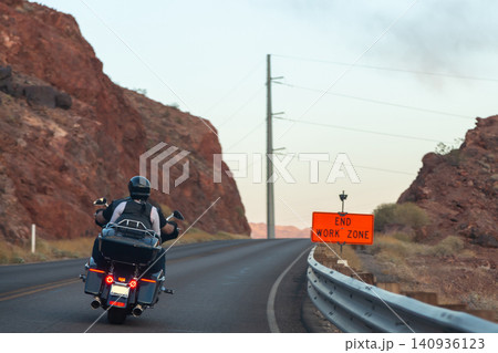 Equipped motorcyclists traveling on winding Equipped motorcyclists traveling on winding 140936123