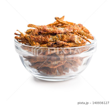 Crispy Fried Small Fish Snack Pile in Glass Bowl Golden Deep-Fried Seafood Appetizer Crispy Fried Small Fish Snack Pile in Glass Bowl Golden Deep-Fried Seafood Appetizer 140936127