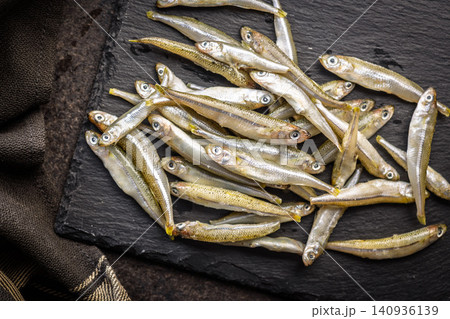 Fresh Small Fish Pile On Dark Surface Seafood Market Bait Smelt Raw Catch Fresh Small Fish Pile On Dark Surface Seafood Market Bait Smelt Raw Catch 140936139