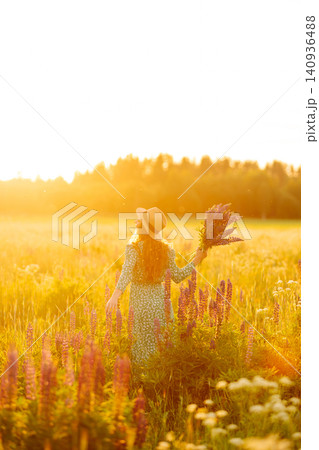 Young woman enjoying nature at sunset while walking. Nature concept. 140936488
