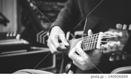 black and white male musician hands playing guitar in home studio. recording, music concept black and white male musician hands playing guitar in home studio. recording, music concept 140936889