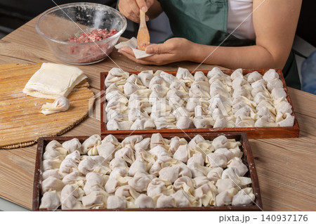 raw Wrapped Wontons Ready for Cooking, Traditional Chinese Dumplings raw Wrapped Wontons Ready for Cooking, Traditional Chinese Dumplings 140937176