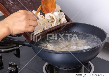 boiling Wontons in Hot Water, Traditional Chinese Dumpling Cooking boiling Wontons in Hot Water, Traditional Chinese Dumpling Cooking 140937178