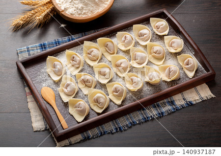 raw Wrapped Wontons, Traditional Chinese Dumplings Ready for Cooking raw Wrapped Wontons, Traditional Chinese Dumplings Ready for Cooking 140937187