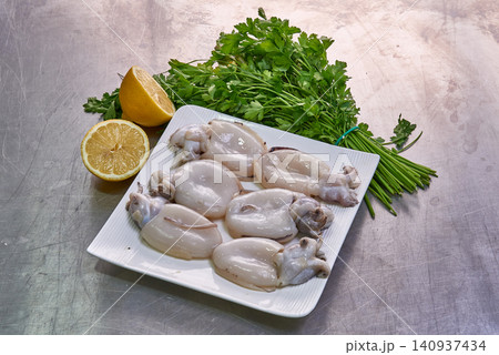 Cuttlefish on a white plate with parsley and lemon Cuttlefish on a white plate with parsley and lemon 140937434