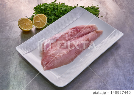 Fillet of Nile perch on a white plate with parsley and lemon 140937440