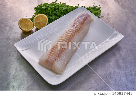 Cod fillet on a white plate with parsley and lemon Cod fillet on a white plate with parsley and lemon 140937443