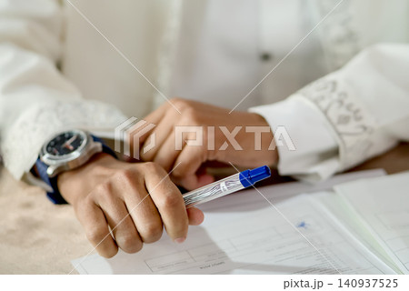 Islamic Marriage Contract Ceremony (Akad Nikah) - Religious Officiant Joining Hands with Groom During Ijab Qabul Ritual Islamic Marriage Contract Ceremony (Akad Nikah) - Religious Officiant Joining Hands with Groom During Ijab Qabul Ritual 140937525