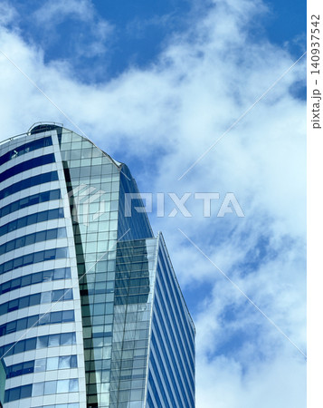 Futuristic Modern Glass Architecture Design Against Cloud Sky Futuristic Modern Glass Architecture Design Against Cloud Sky 140937542