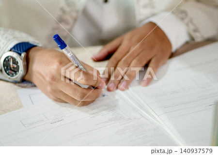 Close-Up of Marriage Certificate Pages During Religious Ceremony 140937579