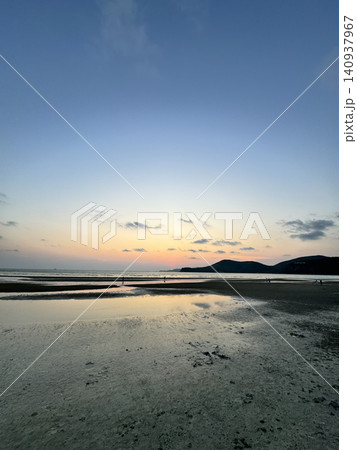 Scenic Coastal Landscape With Beach River Mouth And Mountains at Sunset 140937967