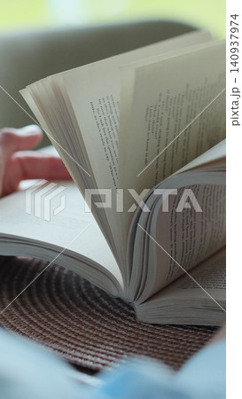 Vertical video Close-up unrecognizable woman reading a book. Vertical video Close-up unrecognizable woman reading a book. 140937974