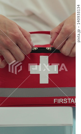 Vertical video Woman open the first aid kit at home. First aid kit. Vertical video Woman open the first aid kit at home. First aid kit. 140938134