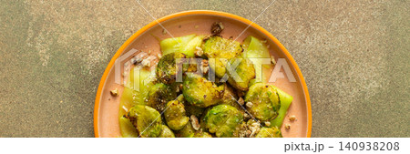 Brussels sprouts and zucchini slices are on a plate and topped with chopped walnuts. This dish can be served for breakfast or lunch. It is a healthy choice for any meal, banner Brussels sprouts and zucchini slices are on a plate and topped with chopped walnuts. This dish can be served for breakfast or lunch. It is a healthy choice for any meal, banner 140938208
