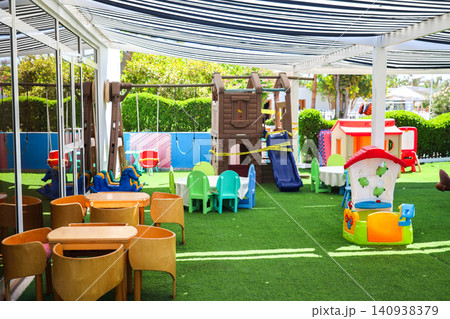 Children's playground, a fun and safe outdoor space for play and exploration under a sun canopy 140938379