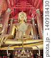 Shining Golden Buddha Image In Intricate Red Temple Interior 140938430