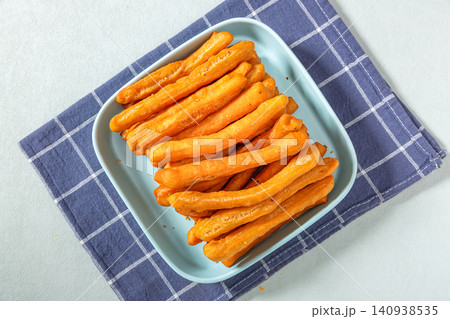 mini Fried Dough Sticks Made of Leavened Dough, Soft and Crispy Chinese Youtiao mini Fried Dough Sticks Made of Leavened Dough, Soft and Crispy Chinese Youtiao 140938535