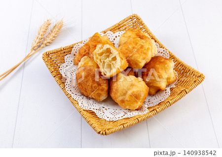 traditional Chinese Breakfast Fried Dough Bites, Golden Puffy Oil Motou Pastry traditional Chinese Breakfast Fried Dough Bites, Golden Puffy Oil Motou Pastry 140938542