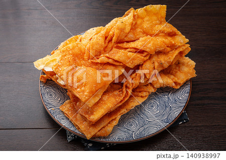 traditional Deep Fried Thin Crisp Ribbon Pastry, Golden Chinese Sweet and Savory Jiao Ye Snack traditional Deep Fried Thin Crisp Ribbon Pastry, Golden Chinese Sweet and Savory Jiao Ye Snack 140938997