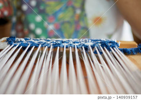 Weaving on a loom frame Weaving on a loom frame 140939157