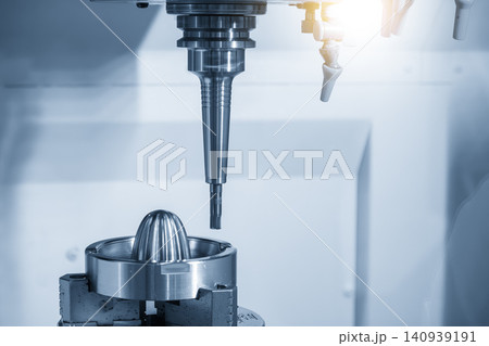 High-precision CNC milling machine performing a finishing cut on metal mold parts with a flat nose end mill tool. High-precision CNC milling machine performing a finishing cut on metal mold parts with a flat nose end mill tool. 140939191