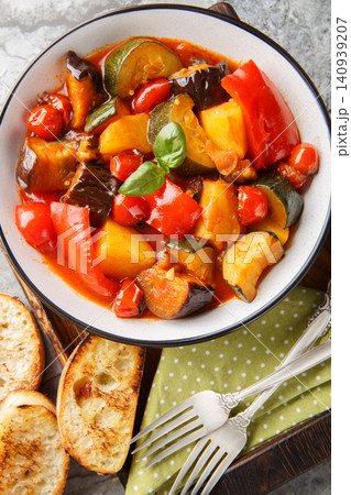 Italian vegetarian Ciambotta vegetable stew closeup on the plate on the table. Vertical top view Italian vegetarian Ciambotta vegetable stew closeup on the plate on the table. Vertical top view 140939207