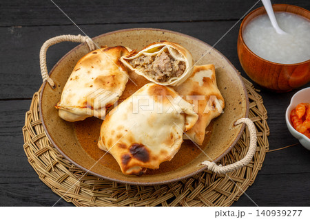 traditional Xinjiang Roasted Mutton Buns, Crispy Clay Oven Baked Samsa with Meat Filling traditional Xinjiang Roasted Mutton Buns, Crispy Clay Oven Baked Samsa with Meat Filling 140939277