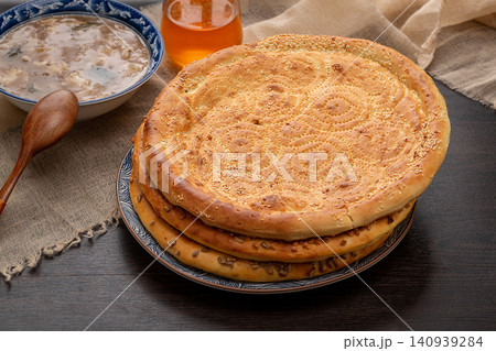 large Round Xinjiang Naan Flatbread with Traditional Stamped Patterns and Sesame 140939284