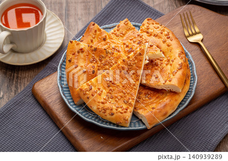 xinjiang Naan Flatbread Topped with Roasted Peanuts, Traditional Nutty Flavor Flatbread xinjiang Naan Flatbread Topped with Roasted Peanuts, Traditional Nutty Flavor Flatbread 140939289