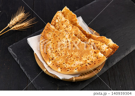xinjiang Naan Flatbread Seasoned with Cumin, Traditional Aromatic Roasted Silk Road Bread xinjiang Naan Flatbread Seasoned with Cumin, Traditional Aromatic Roasted Silk Road Bread 140939304