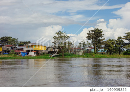 wooden stilt houses belonging to riverside dwellers along banks of tropical river. nearby Manaus, Brazil wooden stilt houses belonging to riverside dwellers along banks of tropical river. nearby Manaus, Brazil 140939823