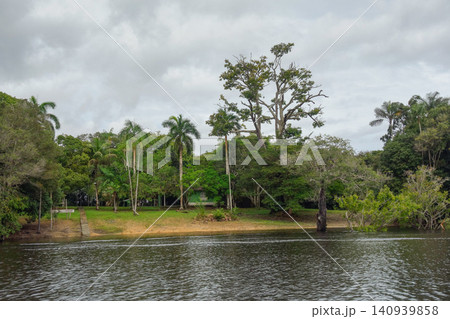 flooded riverbanks of amazon rainforest with riverside wooden houses, nearby Manaus, Brazil flooded riverbanks of amazon rainforest with riverside wooden houses, nearby Manaus, Brazil 140939858