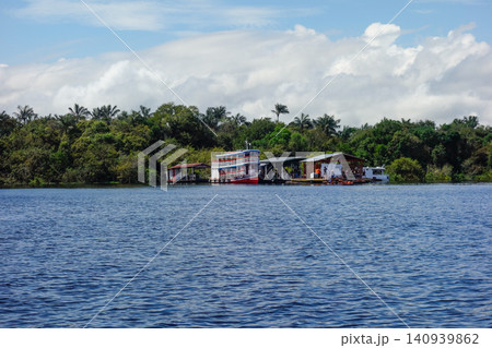 Floating wooden houses of riverside dwellers on banks of tropical river. nearby Manaus, Brazil Floating wooden houses of riverside dwellers on banks of tropical river. nearby Manaus, Brazil 140939862