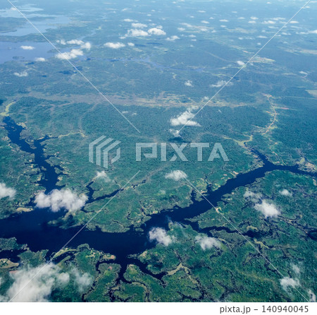 Aerial view over immense Amazon rainforest with a dark river cutting through forest. Amazonas, Brazil Aerial view over immense Amazon rainforest with a dark river cutting through forest. Amazonas, Brazil 140940045