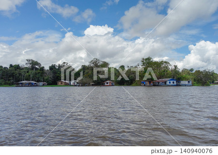 Floating wooden houses of riverside dwellers on banks of tropical river. nearby Manaus, Brazil Floating wooden houses of riverside dwellers on banks of tropical river. nearby Manaus, Brazil 140940076