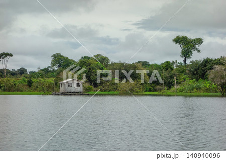 flooded riverbanks of amazon rainforest with riverside wooden houses, nearby Manaus, Brazil flooded riverbanks of amazon rainforest with riverside wooden houses, nearby Manaus, Brazil 140940096