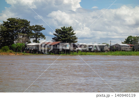 wooden stilt houses belonging to riverside dwellers along banks of tropical river. nearby Manaus, Brazil wooden stilt houses belonging to riverside dwellers along banks of tropical river. nearby Manaus, Brazil 140940119