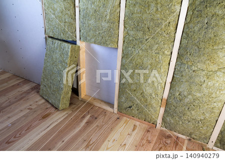 Wooden frame for future walls with drywall plates insulated with rock wool and fiberglass insulation staff for cold barrier. Comfortable warm home, economy, construction and renovation concept. 140940279