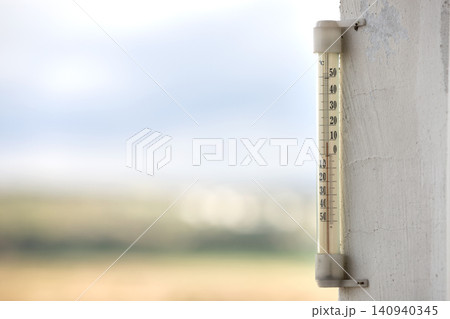 Alcohol glass thermometer Celsius outside on bright blurred light outdoors copy space background. Alcohol glass thermometer Celsius outside on bright blurred light outdoors copy space background. 140940345