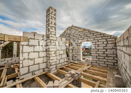 Building site of a house under construction made from white foam concrete blocks. Building site of a house under construction made from white foam concrete blocks. 140940363