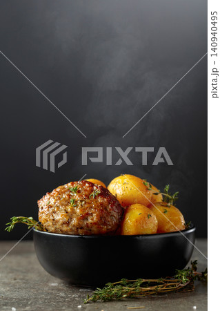 Roasted potatoes with cutlet and thyme. Roasted potatoes with cutlet and thyme. 140940495