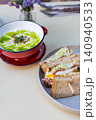 Close-up of a warm bowl of creamy broccoli soup garnished with fresh cream 140940533