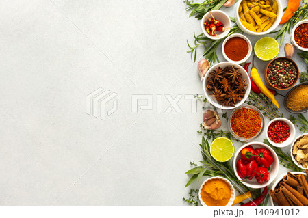 An array of culinary herbs and spices arranged on a gray background, adding aromatic accents perfect for enhancing flavor, top view and copy space An array of culinary herbs and spices arranged on a gray background, adding aromatic accents perfect for enhancing flavor, top view and copy space 140941012