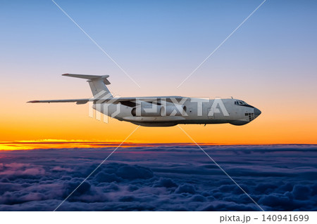 White wide body transport freight airplane flying above the cumulus sunrise sky White wide body transport freight airplane flying above the cumulus sunrise sky 140941699