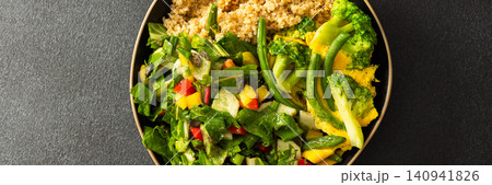 This healthy breakfast consists of a quinoa bowl served with boiled eggs, green beans, and broccoli, alongside a fresh salad. It offers a nutritious start to the day, banner 140941826
