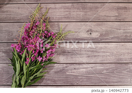 Fireweed flowers on a wooden table, herbal remedies, alternative folk medicine concept, green pharmacy advertisement, collection of useful herbs for folk medicine, source of vitamins Fireweed flowers on a wooden table, herbal remedies, alternative folk medicine concept, green pharmacy advertisement, collection of useful herbs for folk medicine, source of vitamins 140942773