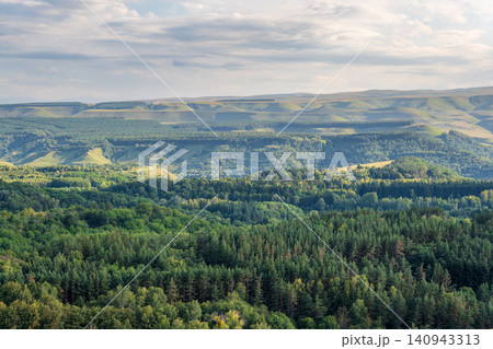 Layers of green mountains and hills in the haze during sunset. Panoramic View of Green hills and Meadow. Layers of green mountains and hills in the haze during sunset. Panoramic View of Green hills and Meadow. 140943313